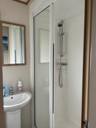 a bathroom with a shower and a sink at Uisge Beatha in Dornoch