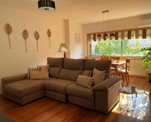 a living room with a couch and a table at Viseu Home in Viseu