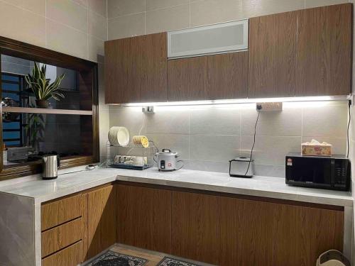 a kitchen with a sink and a microwave on a counter at Lucky Home @ Quintet Tanah Rata in Cameron Highlands