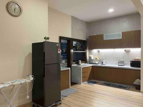 a kitchen with a black refrigerator in a room at Lucky Home @ Quintet Tanah Rata in Cameron Highlands