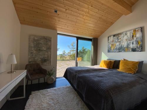 a bedroom with a bed and a desk and a window at Seaside Rendezvous in Kalana