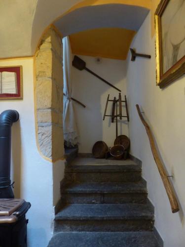 a stairway in a house with a stone wall at B&b Ammentos in Magomadas