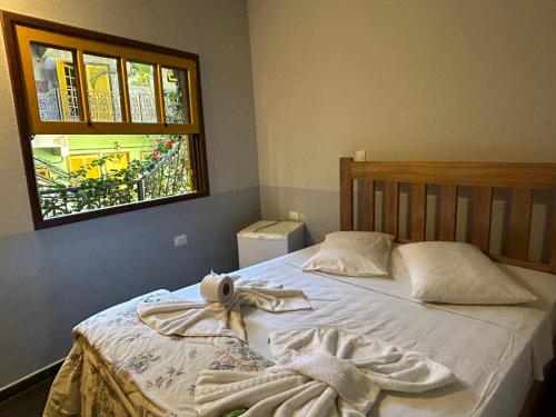 Ένα ή περισσότερα κρεβάτια σε δωμάτιο στο Hotel dos Sonhos