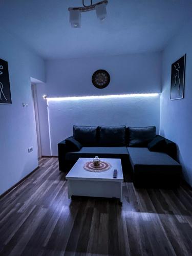a living room with a black couch and a table at La Mary in Old Town in Sibiu