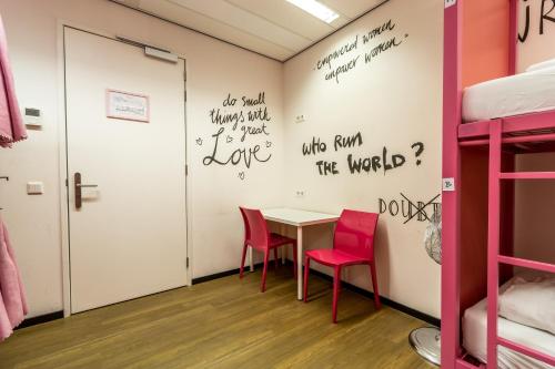 a room with a table and two chairs at Hostelle - women only hostel Amsterdam in Amsterdam