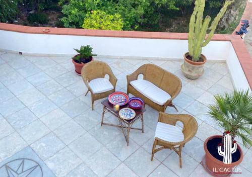 eine Terrasse mit 4 Stühlen und einem Tisch in der Unterkunft Il Cactus: una piccola oasi in paese in Favignana