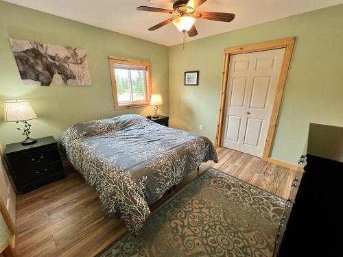 a bedroom with a bed and a ceiling fan at Denali Park 2 Bedroom Mom in Law in Healy