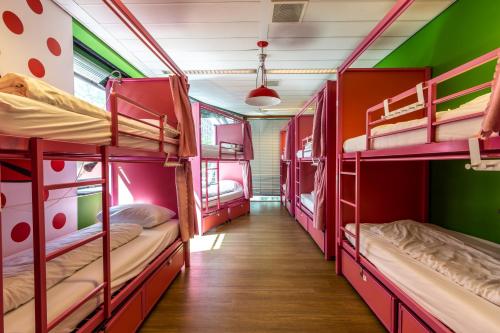 a corridor of a dorm room with bunk beds at Hostelle - women only hostel Amsterdam in Amsterdam