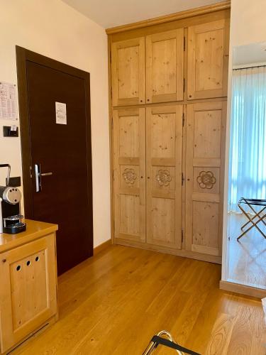 a room with wooden cabinets and a door at Rutzer Hotel Ristorante & Panoramic SPA in Asiago