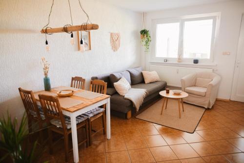 a living room with a couch and a table at Ferienwohnung Nr 4 Boddenblick Kanu Natur Rügen in Zudar