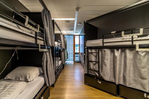 two bunk beds in a room with a hallway at Hostelle - women only hostel Amsterdam in Amsterdam