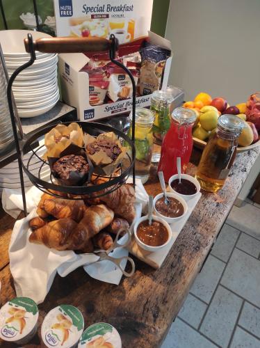 a table with a bunch of pastries and other breakfast foods at Agriturismo ValFraja in Cembra