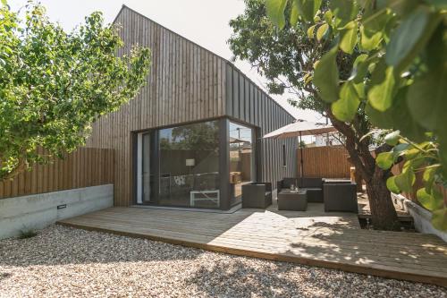 a house with a large glass door on a deck at Villa Arneiro 1 in Vimeiro