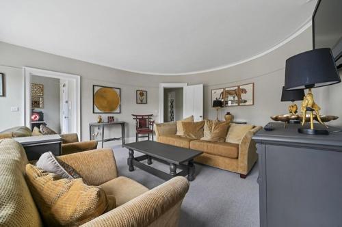 a living room with couches and a table at 119 Flat 2 Northgate st - Stylish one bedroom apartment set within walking distance to town, spacious living space with public car park close by in Bury Saint Edmunds