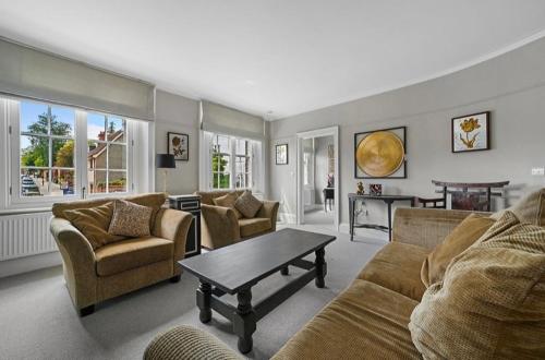 a living room with couches and a coffee table at 119 Flat 2 Northgate st - Stylish one bedroom apartment set within walking distance to town, spacious living space with public car park close by in Bury Saint Edmunds