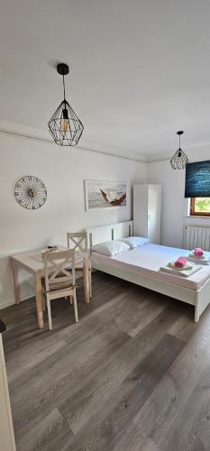 a bedroom with a large bed and a table at Apartment Vesna in Novi Vinodolski