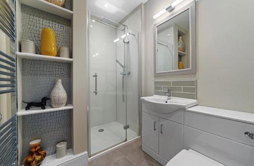 a bathroom with a shower and a sink and a toilet at 119 Northgate st - Delightful one bedroom apartment with fantastic living space in Bury Saint Edmunds