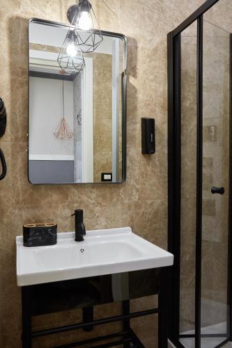 a bathroom with a white sink and a mirror at Hotel Roma Vaticano in Rome
