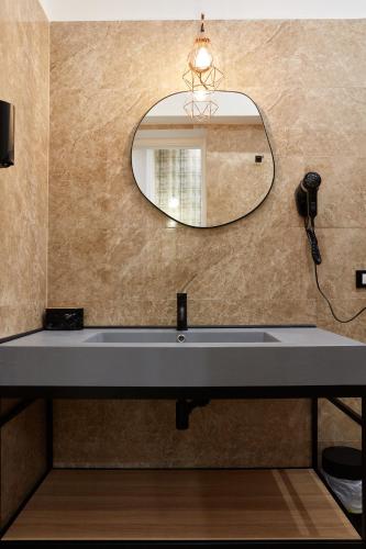 a bathroom with a sink and a mirror at Hotel Roma Vaticano in Rome
