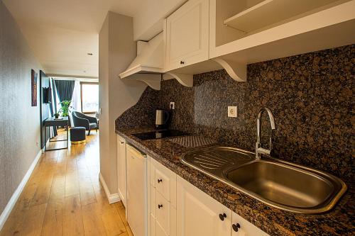 a kitchen with a sink and a counter top at Moss Suites Hotel in Istanbul