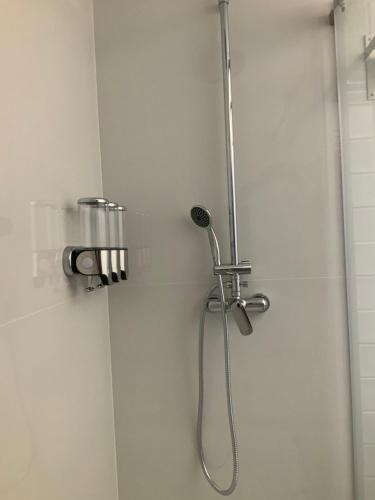 a shower stall with a shower head and a shower at Quinta da Ema 