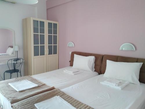 a bedroom with a bed with two towels on it at Studios Spiros Parga in Parga
