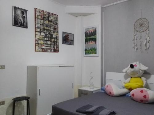 un dormitorio con un osito de peluche sentado en una cama en Stella, en Omegna