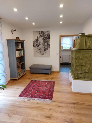 a living room with a couch and a rug at Ferienwohnung Eisenerz 80m² in Eisenerz