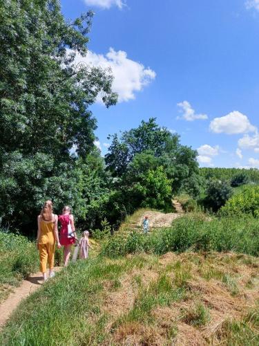 a group of people walking down a trail at Les gîtes de L'Isle Jourdain in Pujaudran