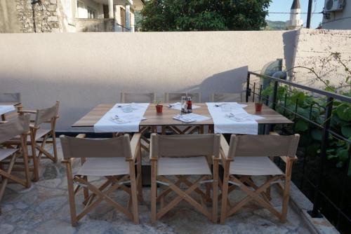 a wooden table and chairs on a patio at Hotel Restoran Humsko in Trebinje