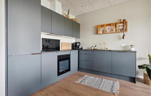 a kitchen with gray appliances and a wooden floor at 3 Bedroom Amazing Home In Thisted in Thisted
