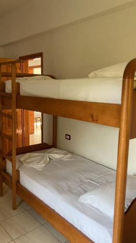 two bunk beds in a room with a mirror at Vila 3 in Himare
