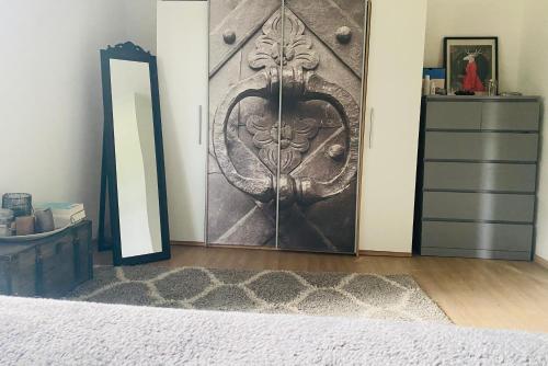 a bedroom with a wooden door and a mirror at Lend city house in Graz