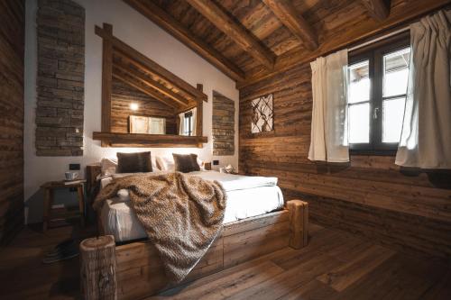 a bedroom with a bed with a blanket on it at Ledro Mountain Chalet in Ledro
