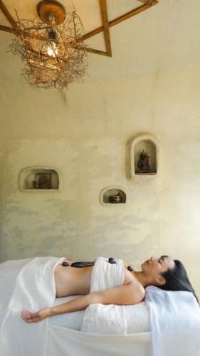 a woman laying on a bed in a room at Kafuya miyagi in Ikemi