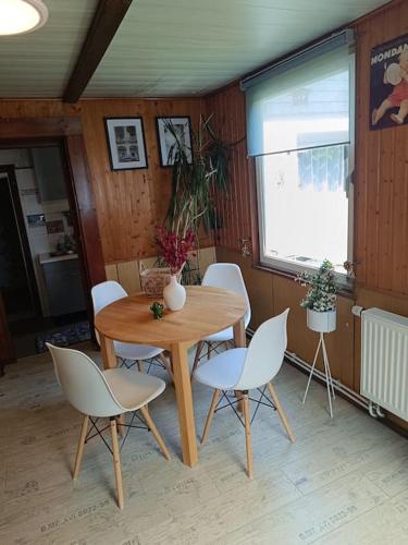 a wooden table and chairs in a room at Haus Luise in Stapelburg