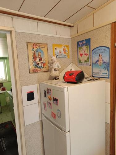 a kitchen with a refrigerator and a red phone on top of it at Haus Luise in Stapelburg
