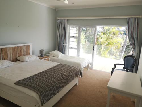 a bedroom with two beds and a sliding glass door at River Bliss in East London
