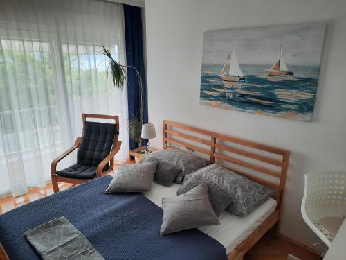 a bedroom with a bed with a blue comforter at Apartments Anita in Crikvenica