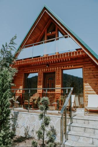 a log cabin with a staircase to the front of it at Star Villas Žabljak in Borje