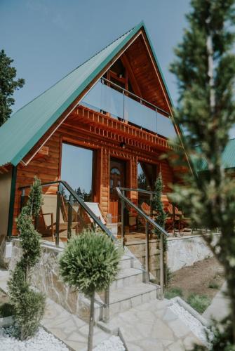 a log cabin with stairs leading up to it at Star Villas Žabljak in Borje