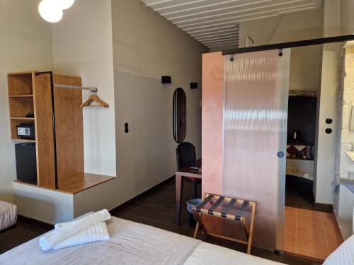 a bedroom with a bed and a chair and a desk at Mosaic Venetian Harbour Suites in Chania Town