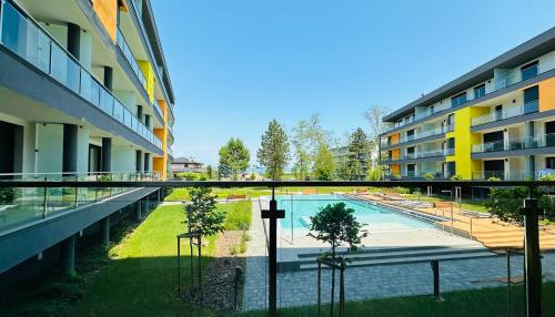 an apartment complex with a swimming pool and buildings at Medencés Panorámás BalAtom apartman in Siófok