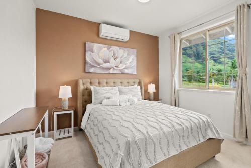 a bedroom with a large bed and a window at #ML Ocean view, Golf, Gazebo and BBQ, we have all! in Waianae