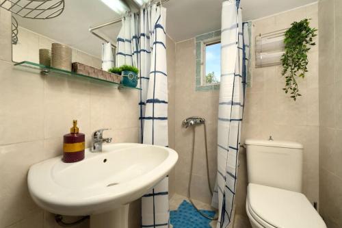 a bathroom with a sink and a toilet and a shower at Traditional Seaview Home Candili in Corfu Town
