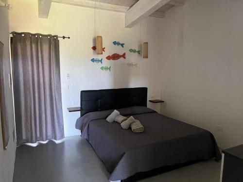 a bedroom with a bed with two towels on it at Affitto frassanito in Otranto