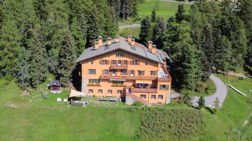 an aerial view of a large house on a hill at Hotel Chesa Spuondas in St. Moritz
