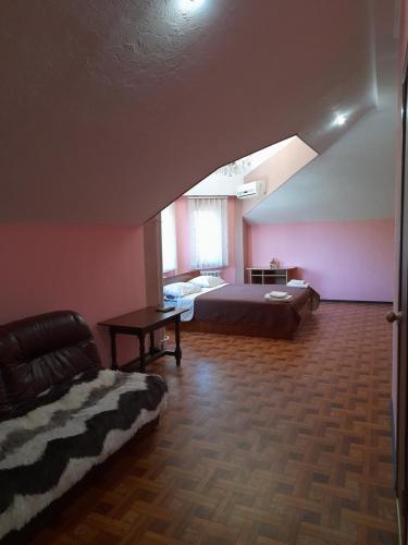 a bedroom with a bed and a couch in a room at SunLake Hotel Osokorki in Kyiv