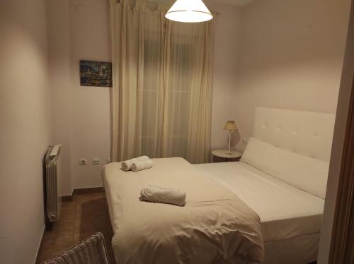 a bedroom with a bed with two towels on it at APARTAMENTO PERFECTO in La Antilla