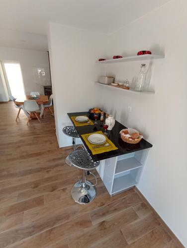 a kitchen with a black counter and a table at Casa da avó Zita in Pombal
